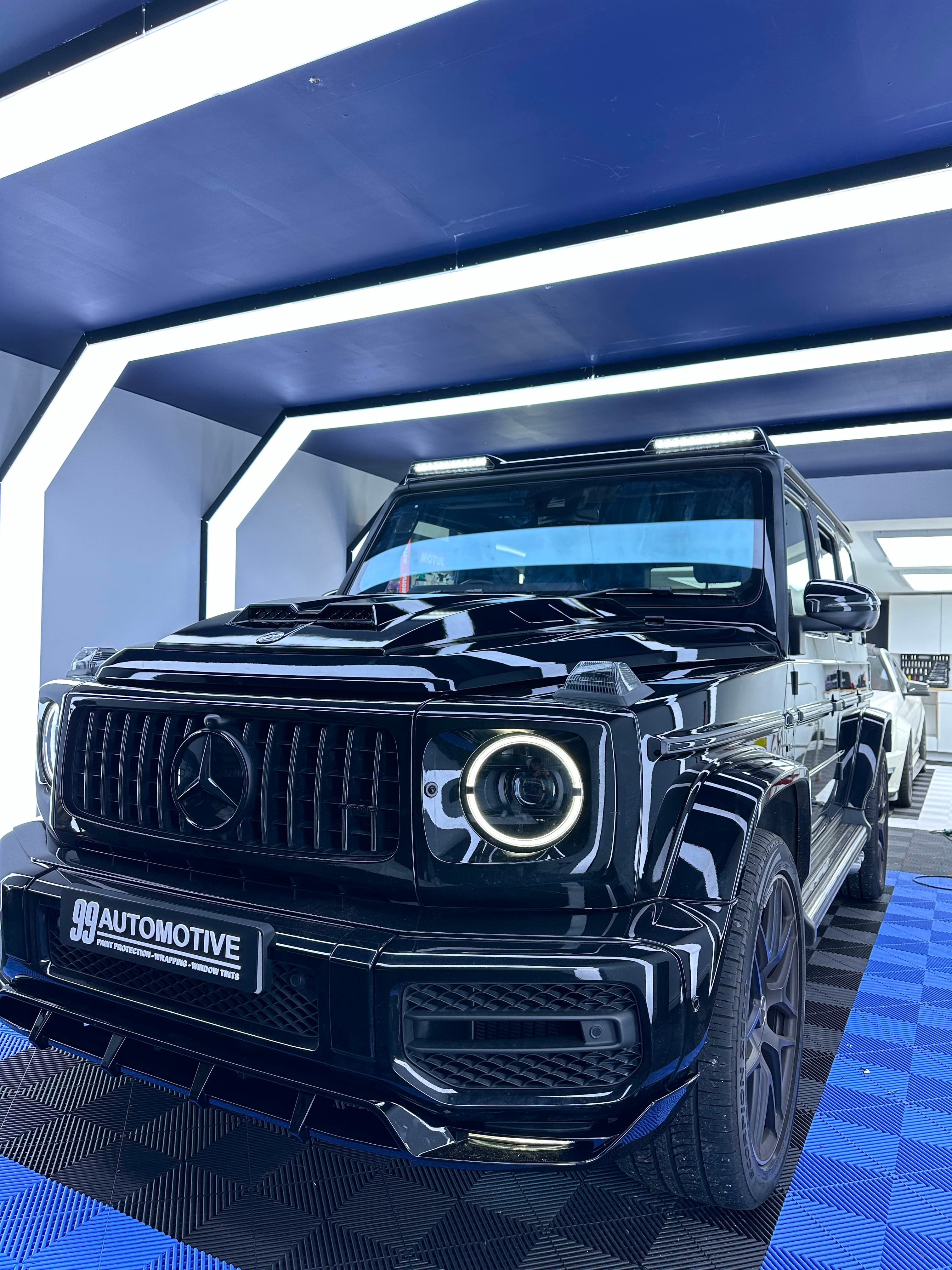 Black Mercedes G-Class, low front three-quarter in the studio