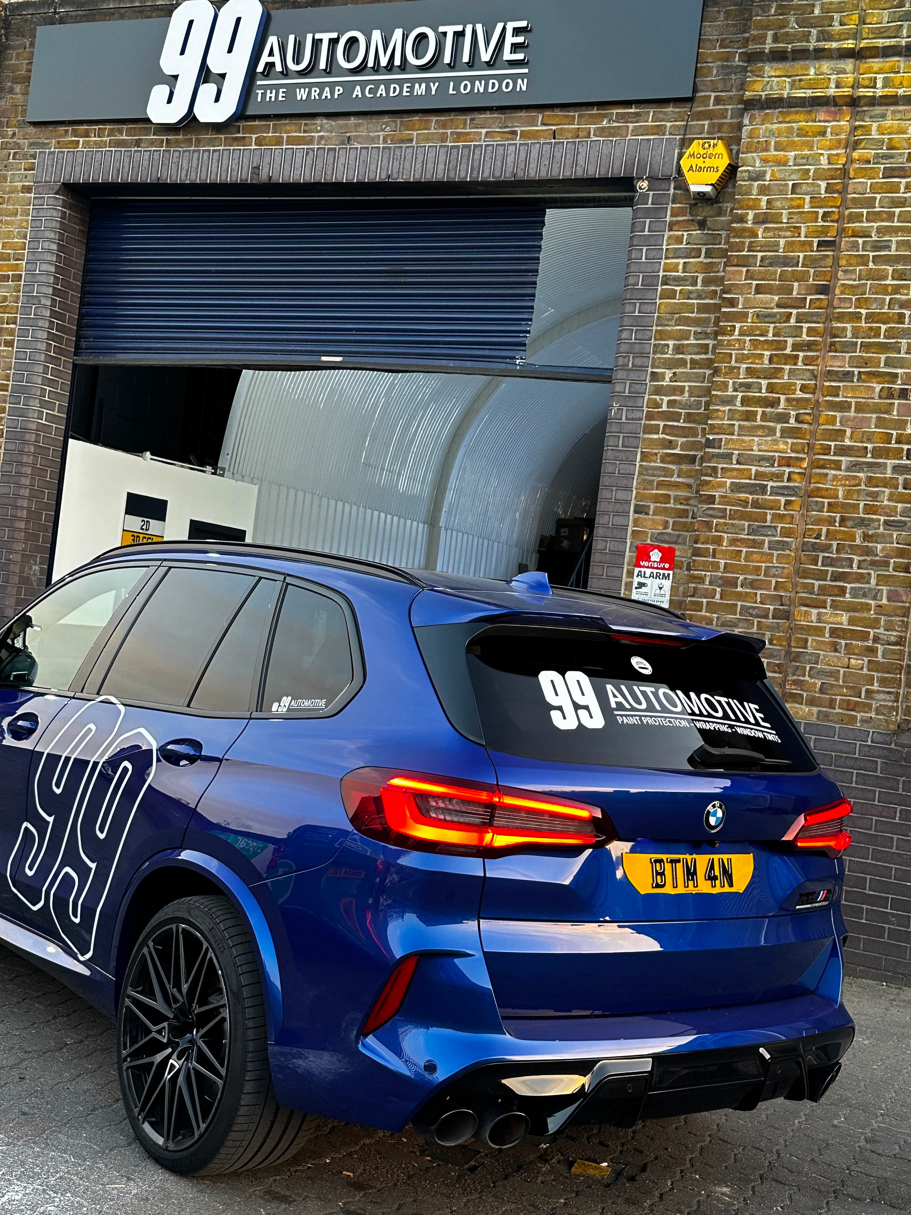 Blue BMW with 99 livery outside the South workshop