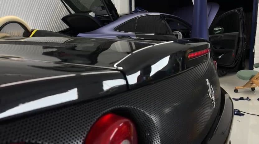 Carbon rear deck and spoiler of a black Ferrari