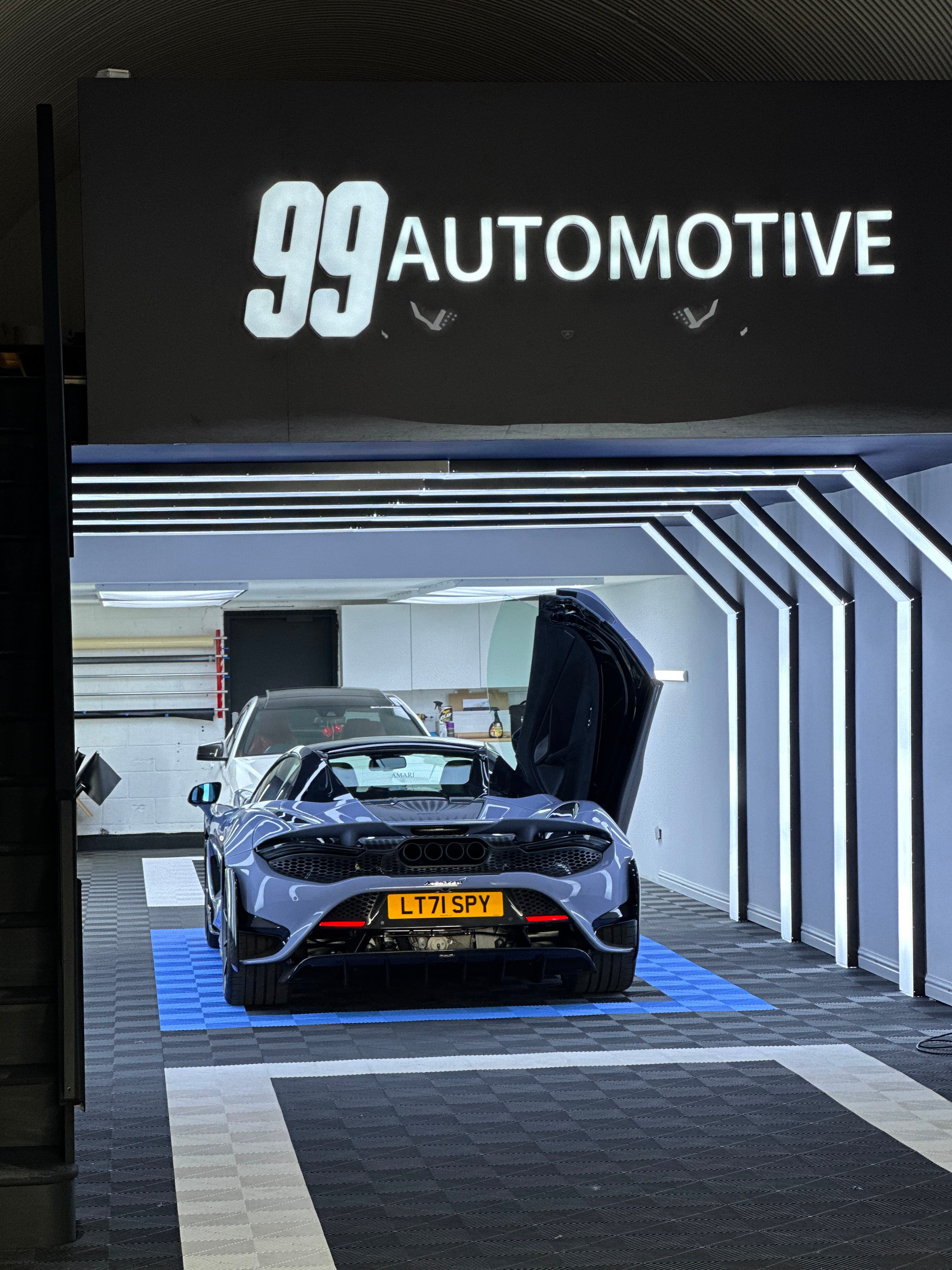 McLaren 765LT Spider, rear, dihedral door up under the 99 sign