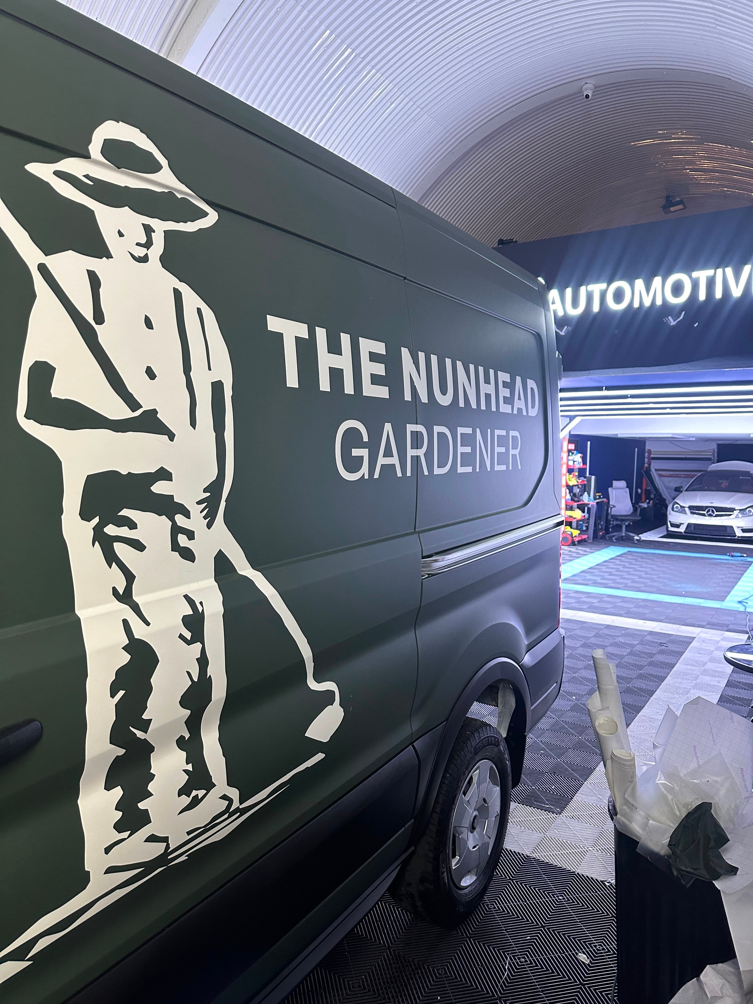 Olive wrap on a van for The Nunhead Gardener, backing paper in the bin